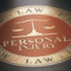 Personal injury written with golden letters over red and black background. Law concept. 3D illustration.