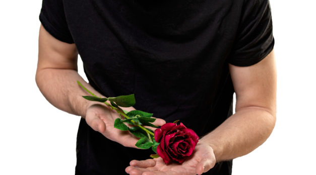 man with red rose in hands. valentine day love beautiful. Copy space