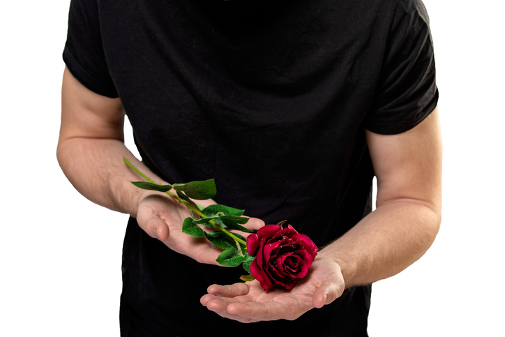 man with red rose in hands. valentine day love beautiful. Copy space